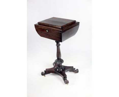 An early 19th Century Irish rosewood Tea Caddy, the fitted lift top body on a pillar support with carved design terminating w