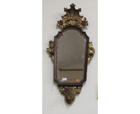A small 19th Century shield shaped carved giltwood Wall Mirror, with shell decoration. (1)