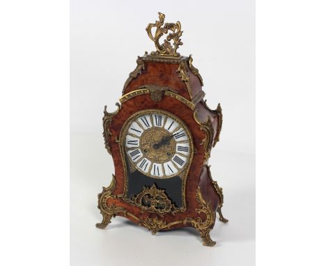 A Louis XV style French Mantle Clock, in burr walnut with ormolu mounts and central brass dial with enamel Roman numerals, 55