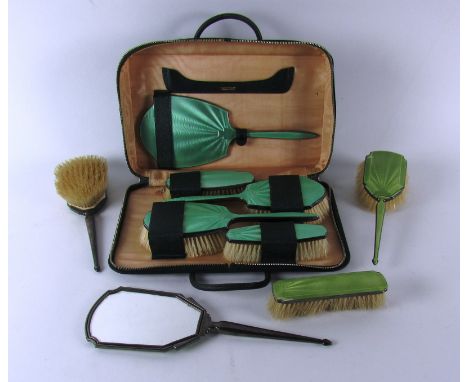 A cased set of silver mounted green enamel Brushes, with matching mirror by Mappin & Webb; together with three lime green bru