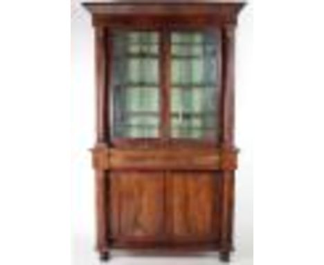A figured mahogany William IV period Bookcase, with pillar supports, the top with two glazed doors over frieze drawer, and tw
