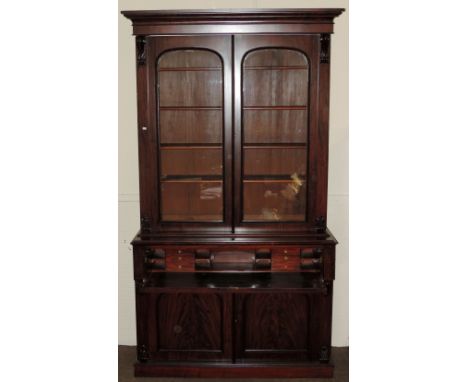 A good large William IV mahogany Bookcase Secretaire, the moulded cornice over two glazed arch doors, the fitted pull out wri