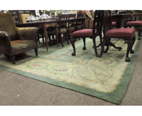 A very fine large 19th Century Donegal hand knotted Carpet, almost square, the lime green centre panel with floral corners, a