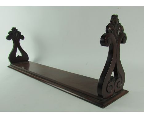 A 19th Century Irish mahogany Table Shelf, with pierced carved ends on moulded base, approx. 92cms (36") long. (1)