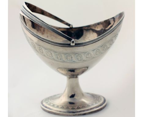 A very good Irish Provincial bright cut helmet shaped Sterling silver Sugar Bowl, with swing handle, on oval base, stamped St