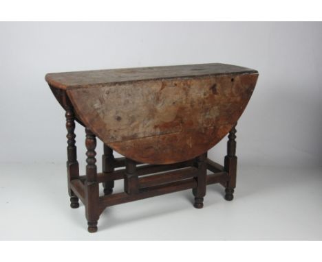 A late 17th Century / early 18th Century yew-wood drop-leaf gate-leg Table, on an oak base with turned support, approx. 100cm