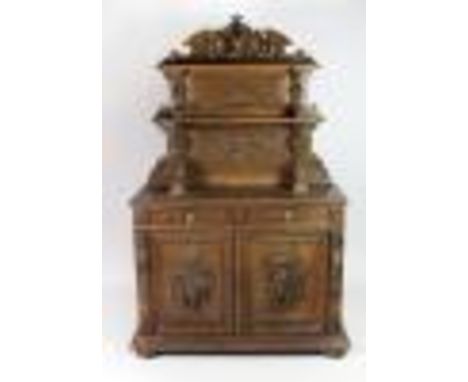 A good quality 18th Century carved light oak Buffet, the carved and shaped top with fruit and deer's head over two shelves, o