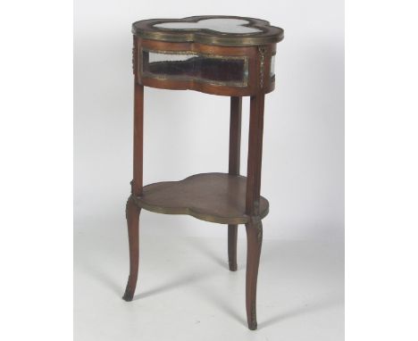 An unusual ormolu mounted mahogany Curio Table, of shamrock shape, with glass panel top and sides and underneath shelf. (1)