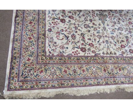 An attractive Middle Eastern cream ground Carpet, with multiple borders, the central panel with bouquet of flowers and surrou