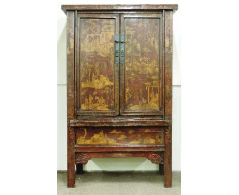 An early 19th Century Chinese red lacquered Cabinet, with two large gilt decorated panel doors over a similar decorated friez