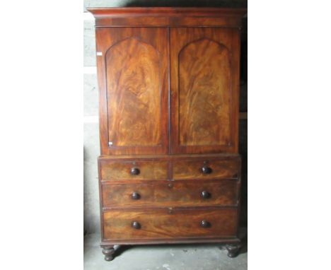 A good quality William IV figured mahogany Gentlemans Wardrobe, with two arched panel doors over chest with two short and two