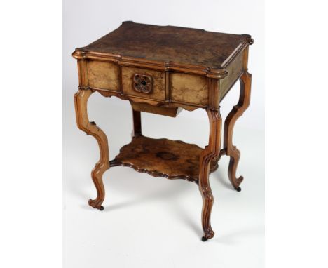 A Victorian walnut lift top Table, the shaped top opening to a compartmented lift out section and mirror back, over a frieze 