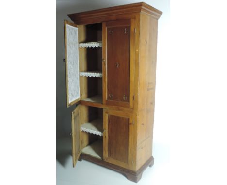 An unusual antique pine and pitch pine Larder Cupboard, the top panel doors with pierced decoration over two smaller panel do