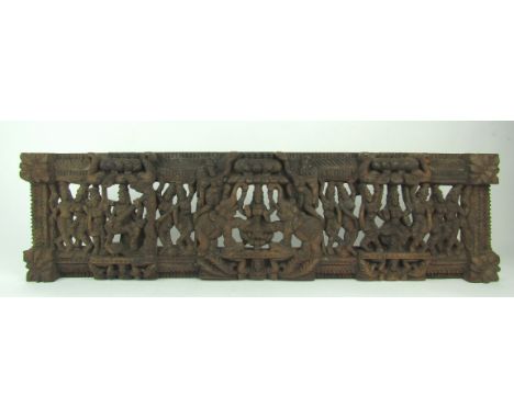 An unusual 20th Century Oriental carved and pierced wooden oblong Panel, depicting multiple figures, elephants, birds, etc., 