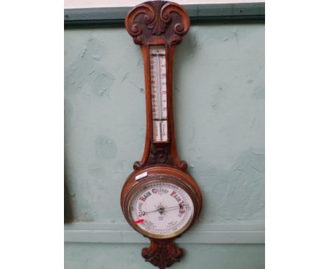 Aneroid barometer with thermometer dial in oak banjo styled carved case