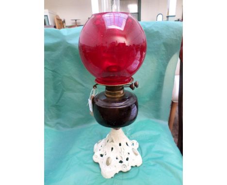 Painted metal based paraffin table lamp with mauve bowl, vivid red shade