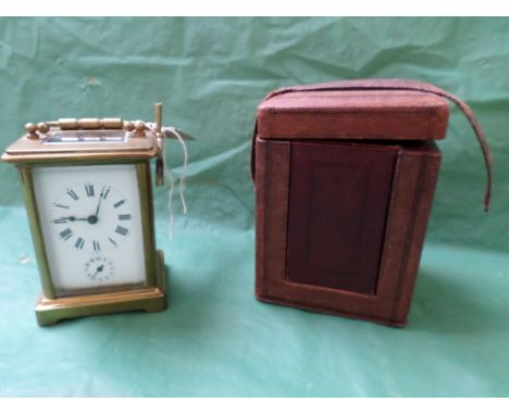 Late Victorian brass carriage clock, enamel two dial roman numerals, together with original brown case