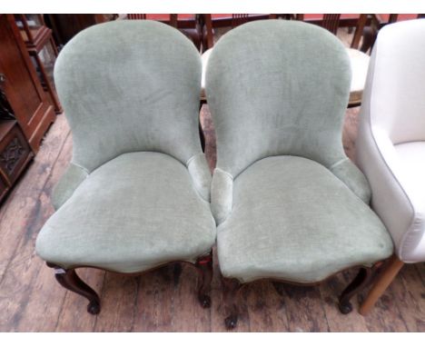 Pair of mahogany framed nursing chairs, the padded backs and seats of each upholstered in light green draylon