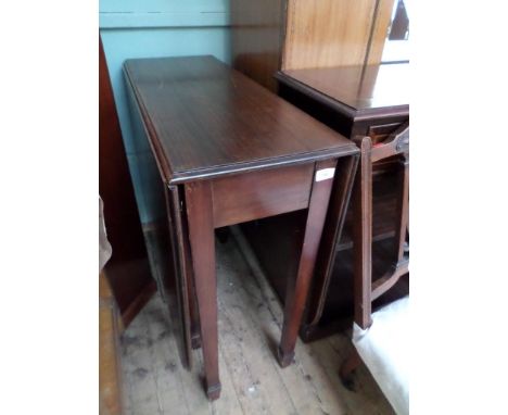 A large modern mahogany gate leg drop leaf dining table