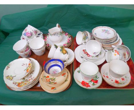 Selection of bone china cups and saucers on two trays