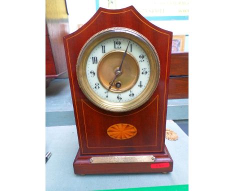 Early 20th century mantel clock with presentation plaque referring to WW1, the circular brass framed enamel dial within inlai