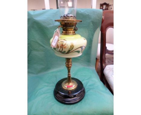 Paraffin table lamp with painted yellow bowl on brass support on circular black painted base