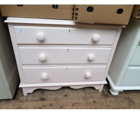 A white and pink painted pine chest of 3 drawers, with bobbin handles on bracket feet