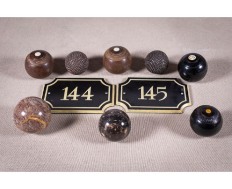 A SET OF NINE VINTAGE EBONY and hardwood lawn bowls, some with makers stamps, number plates etc.Provenance: Patricia Downey D