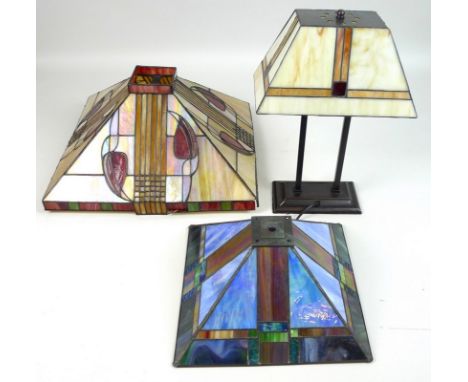 A modern Tiffany style table lamp with stained leaded glass lamp shade, 30 by 18 by 43cm high, together with two similar smal