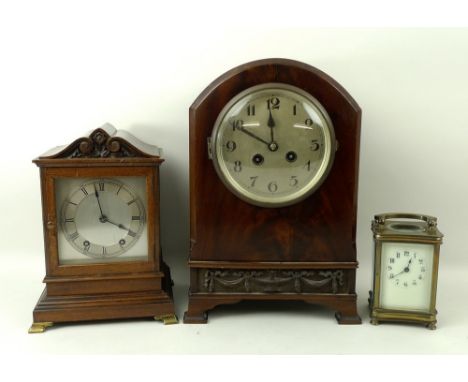 A late Victorian brass carriage clock, the cream dial painted with black Arabic numerals, arched handle, on four small turned