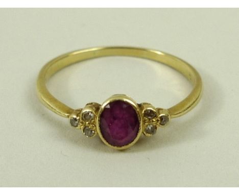 An 18k gold, ruby and diamond ring, circa 1910, the cabochon set ruby flanked either side by three diamonds set to the should