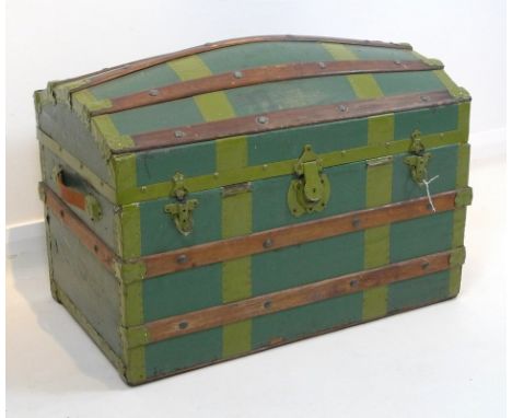 An early 20th century domed wooden steamer trunk, painted green with metal and wooden bindings, leather handles, and complete