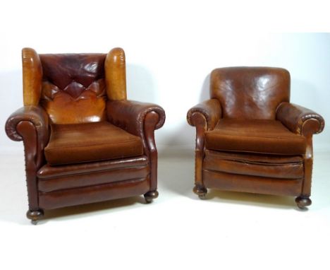 An Edwardian brown leather button back wing arm chair, with scroll over arms, loose seat cushion upholstered in brown velour,