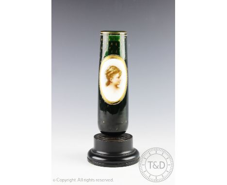 A French Bohemian glass spill vase, circa 1900, the cylindrical green glass vase with an applied panel depicting a female bus