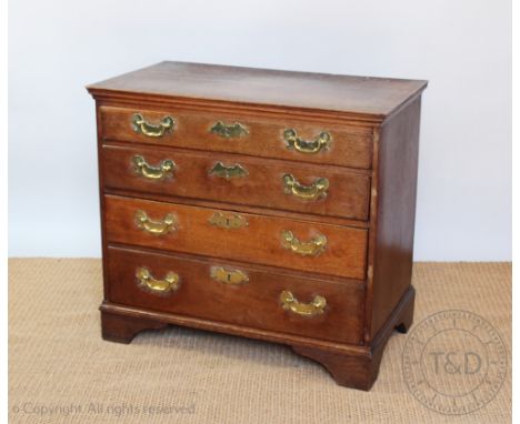 A George III oak chest, of four graduated long drawers, with later brass handles, on bracket feet, 77cm H x 86cm W x 50cm D