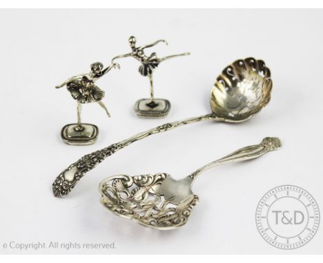 An Art Nouveau sterling silver sifter spoon,with flower head pierced bowl, handled initialled 'C', 12cm long, a silver tea st