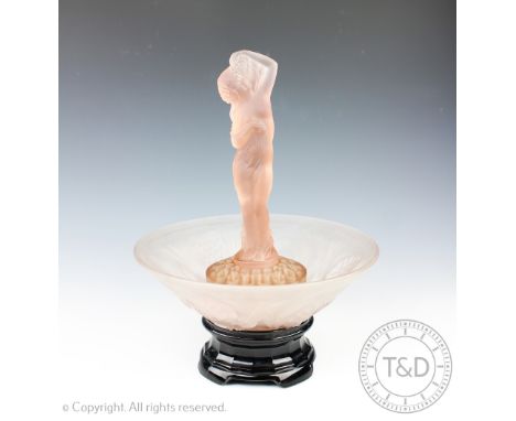 A Art Deco figural glass centrepiece, 'The Water Carrier' by James Jobbling, the frosted pink glass model designed as a scant