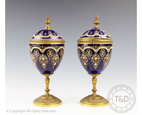 A pair of 19th century French gilt brass and enamel cups and covers, with 'jewelled' detailing, (both at fault), 22cm