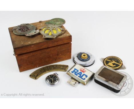 An Iraq Automobile Association car badge, No 528, three other car badges, a Manchester Garages Ltd mount, a Smiths chrome tim