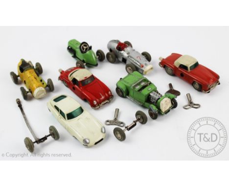 Seven Schuco clock work Micro Racers and Roadsters comprising; Mercedes 1043, Mercedes 190 SL 1044, Porsche 1047, Jaguar E-Ty