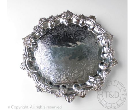A William IV silver salver, 'IW' London 1835, with shell cast scroll rim upon three bracket feet and chased floral and foliat