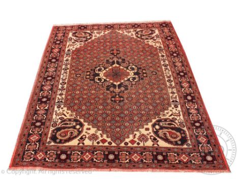 A Kasak hand woven wool carpet, worked with a geometric floral pattern against a red and ivory ground, 286cm x 220cm CONDITIO