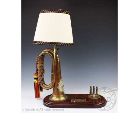 An unusual table lamp of military interest, formed from a copper and brass naval bugle with badge for Gibraltar Royal Marines