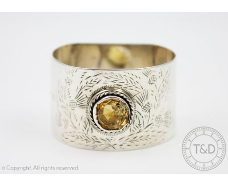 A Victorian silver Scottish design napkin ring, J Goode and Sons, Chester 1900, set with a central citrine ('Cairngorm') with