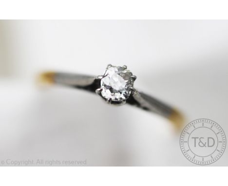 A solitaire diamond ring, the cushion shaped old cut diamond within eight claw, white metal setting and shoulders and plain y