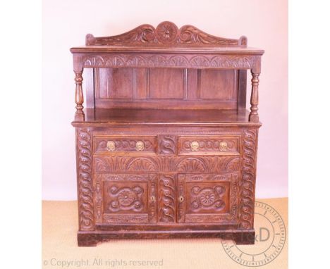 A Victorian late 17th century style carved oak court cupboard, with raised back above two drawers and two doors, on bracket f