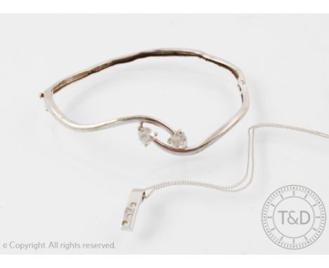 A diamond set white metal pendant stamped '375' with attached fine chain and a white metal bangle set with two heart shaped c