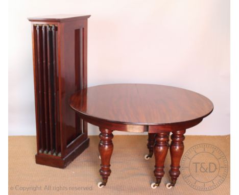 A Victorian mahogany extending dining table, with four spare leaves, on turned legs with fitted brass and ceramic casters, 71