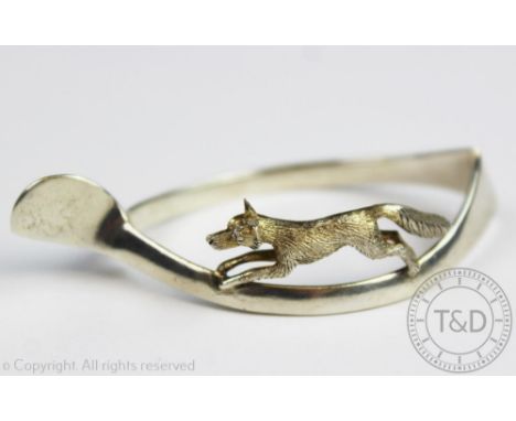 A George V silver figural wishbone napkin ring, C & C Hodgetts, Birmingham 1924, modelled with a running fox, 6.5cm long 