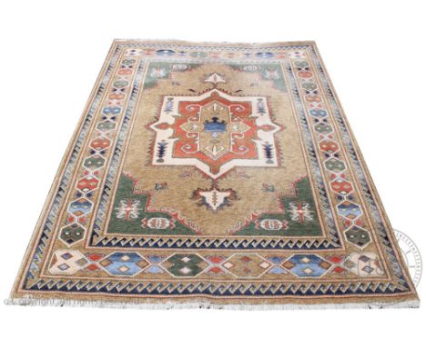 A Belgian machine woven wool carpet, worked with a geometric central medallion against a beige ground, 335cm x 248cm